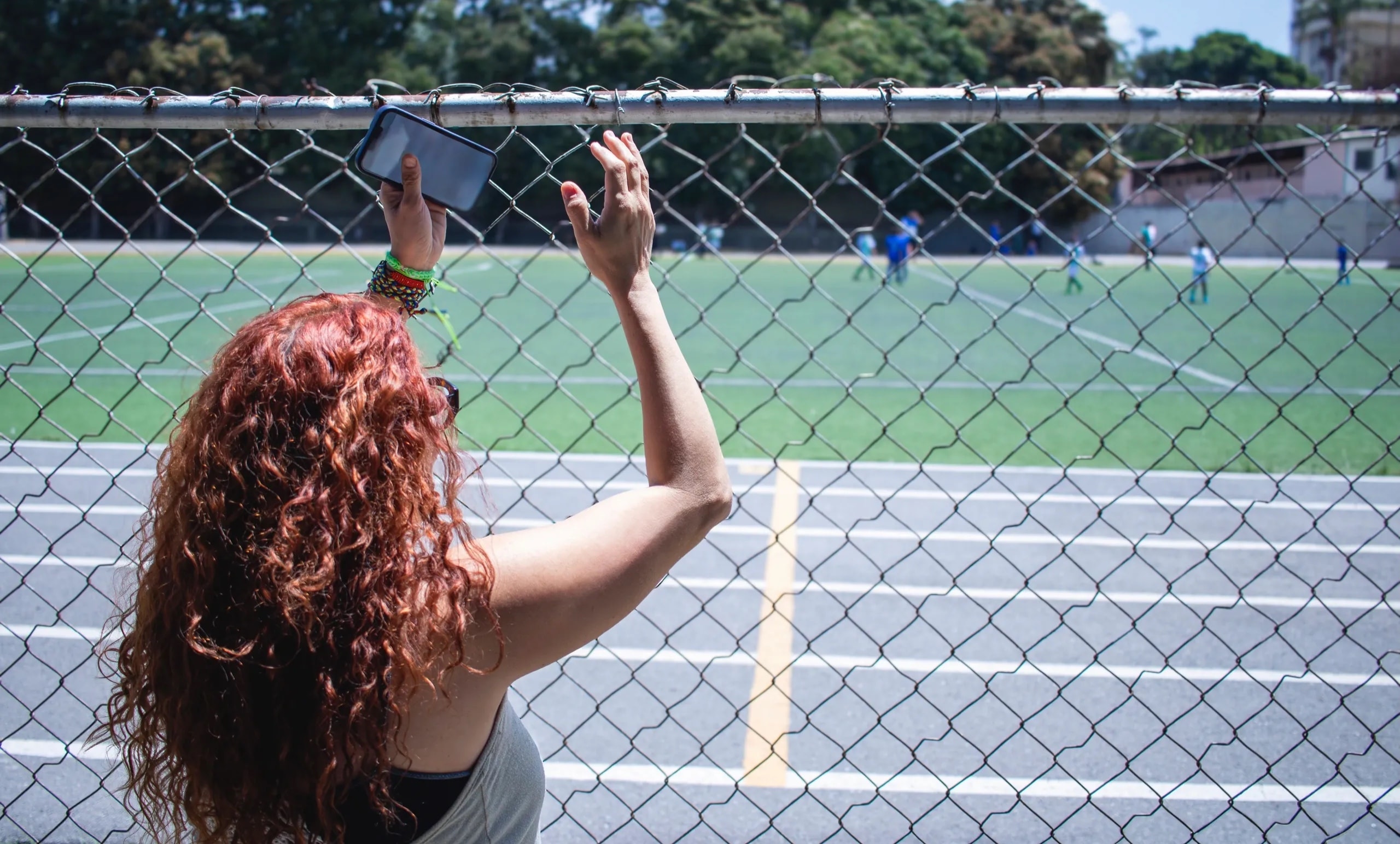 Parent helping young athlete prepare before practice — the quiet moments of the sports journey