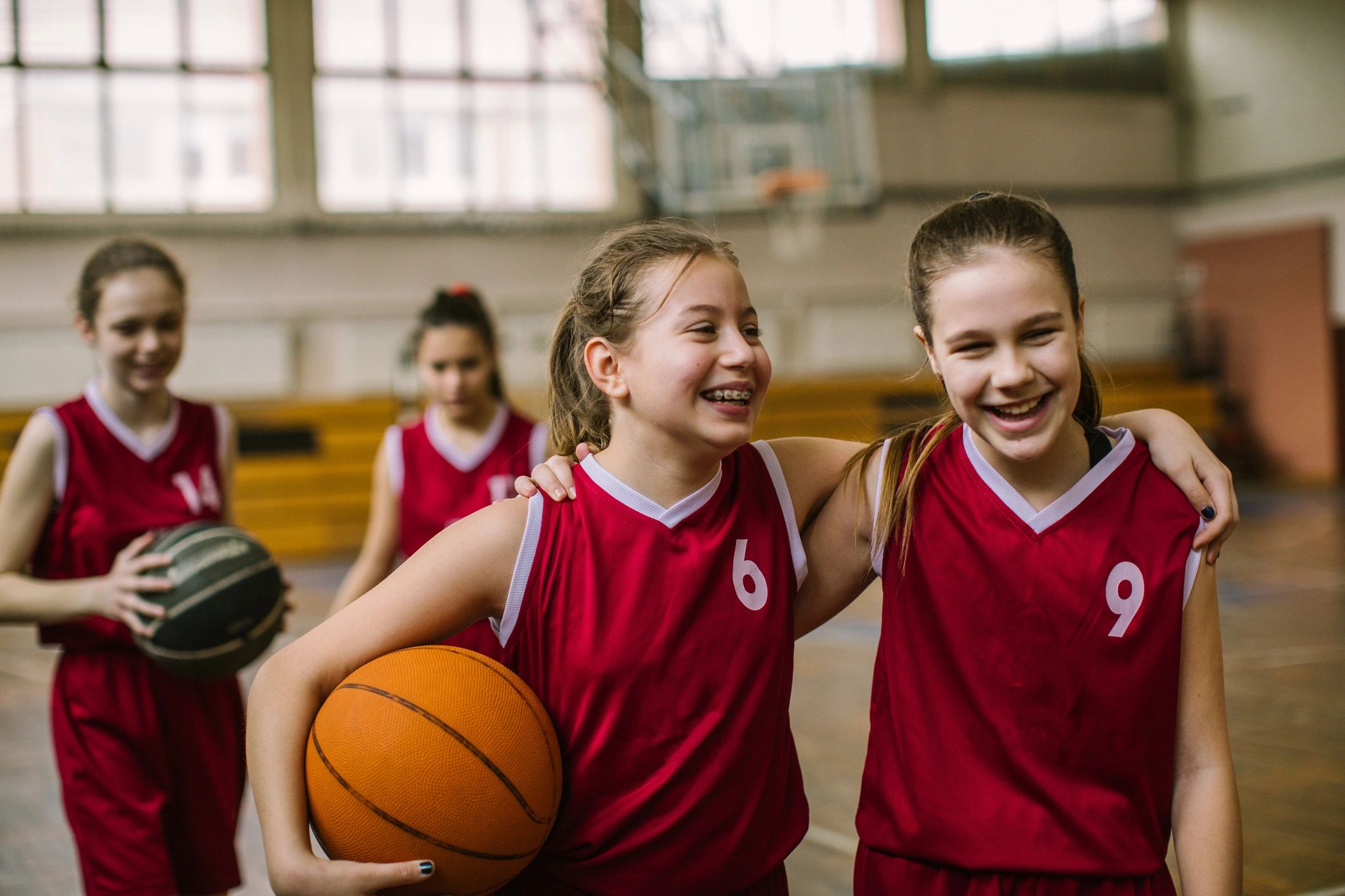 Girls basketball team laughing